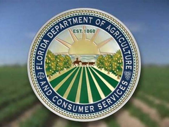 USDA seal in front of growing rows of crops